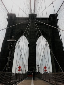A form traveler carefully moving along a curved bridge segment, showcasing precision engineering.