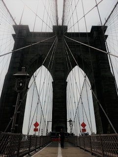 A form traveler carefully moving along a curved bridge segment, showcasing precision engineering.