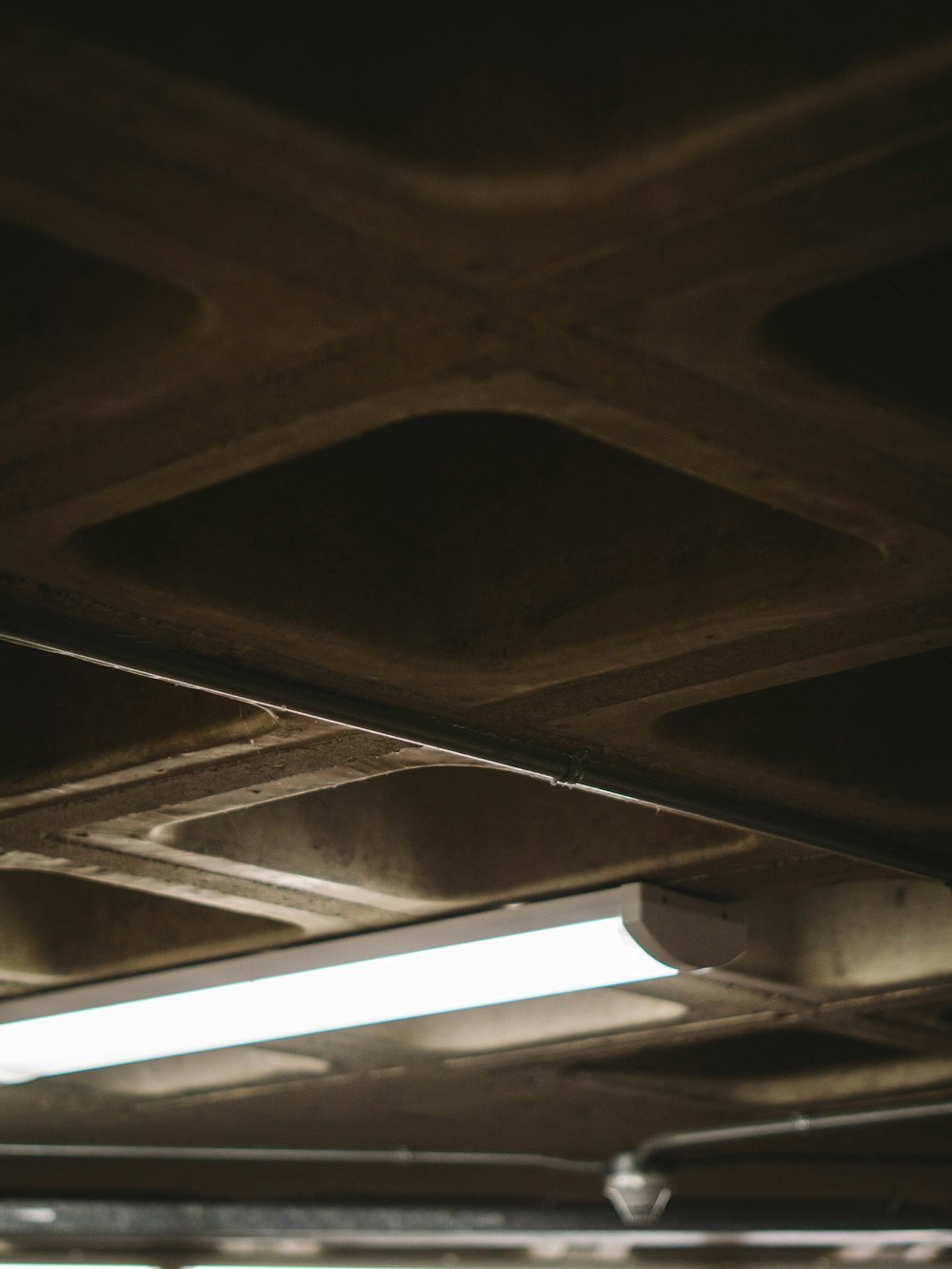 a close up of a street light under a bridge