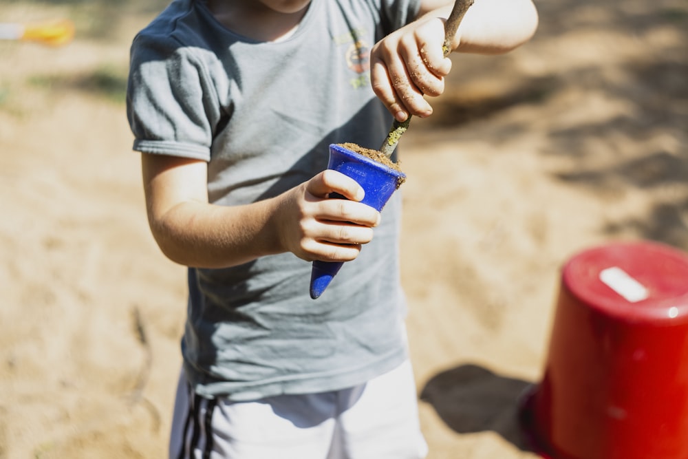 boy in gray shirt playing cone