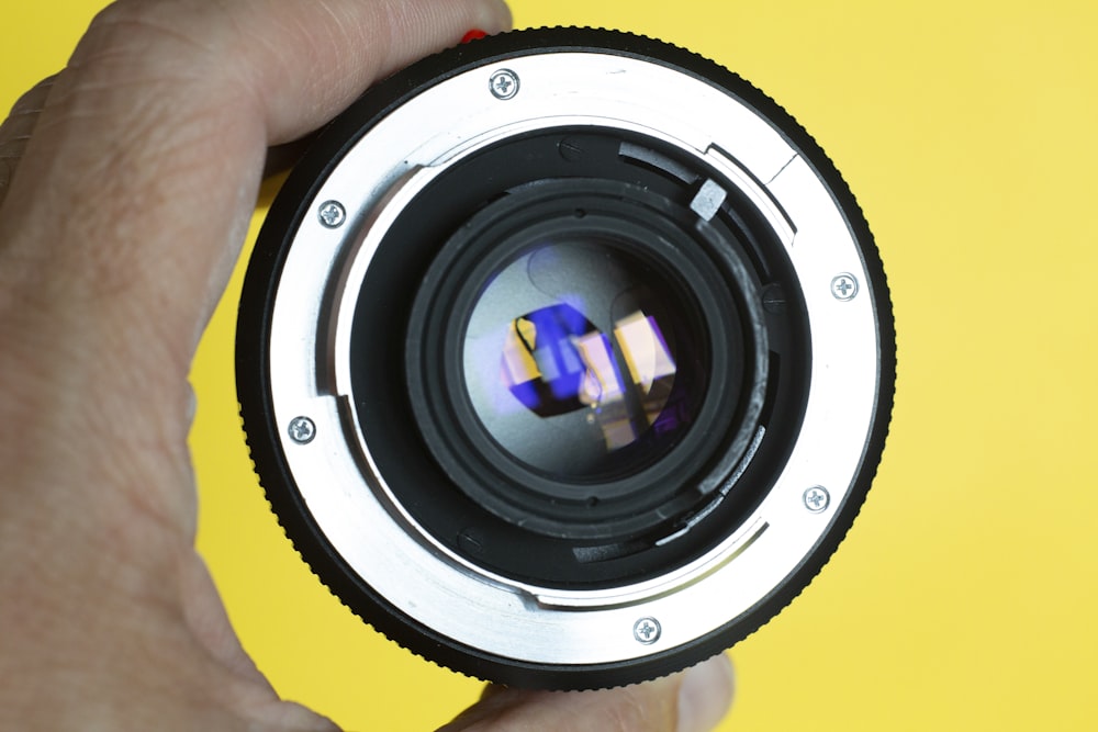 person holding gray camera lens