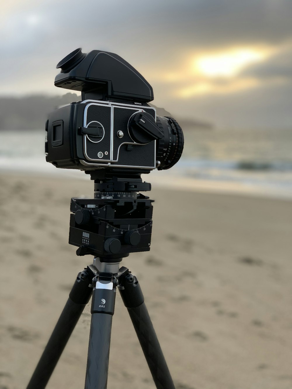 selective focus photography of black DSLR camera with tripod