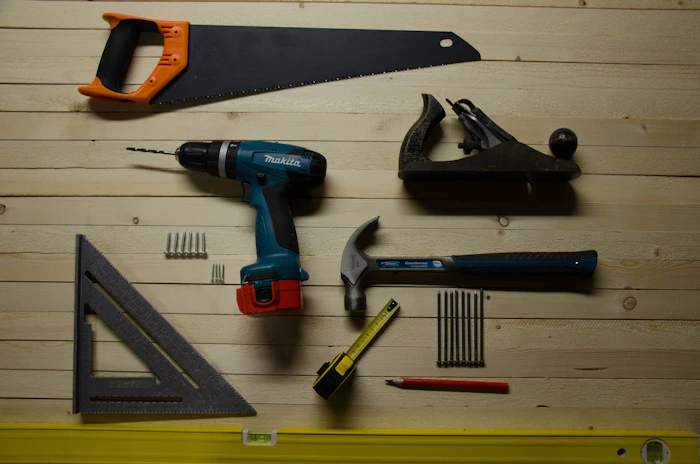 Saw, drill, hammer, square flat lay