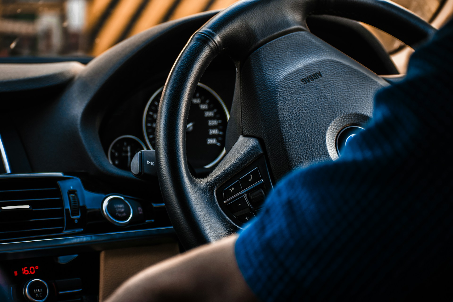 Close-up of a car's dashboard and steering wheel, captured in a detailed 360° interactive presentation with zoom features.