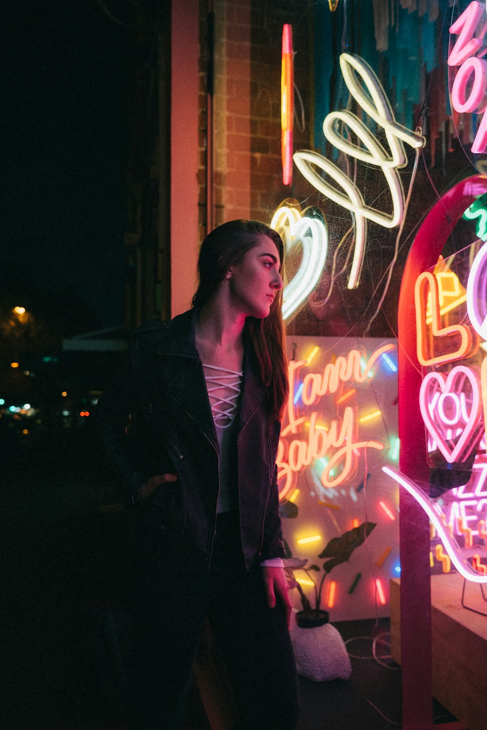 woman looking infront at neon singage