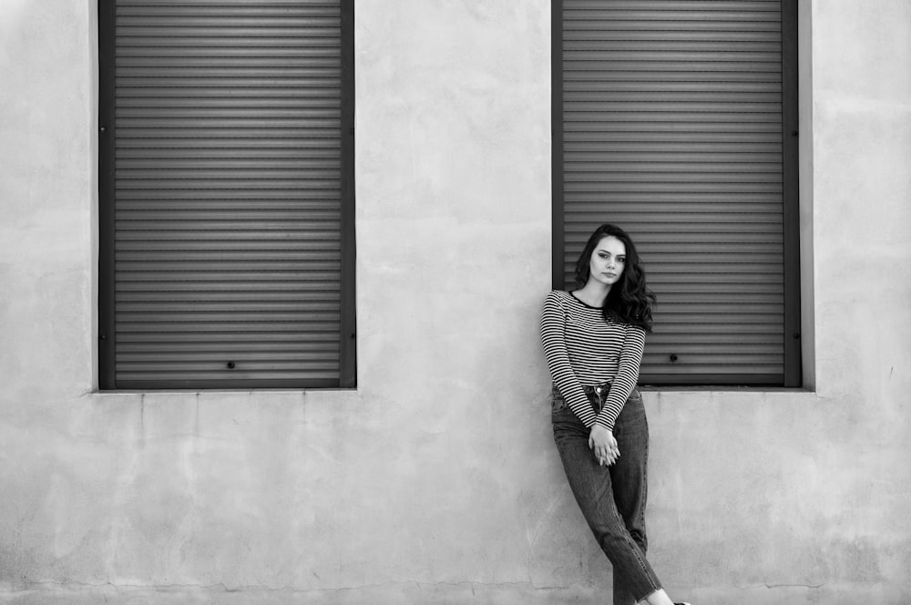 woman leaning on wall