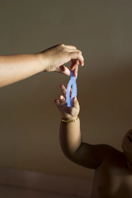 person holding teether