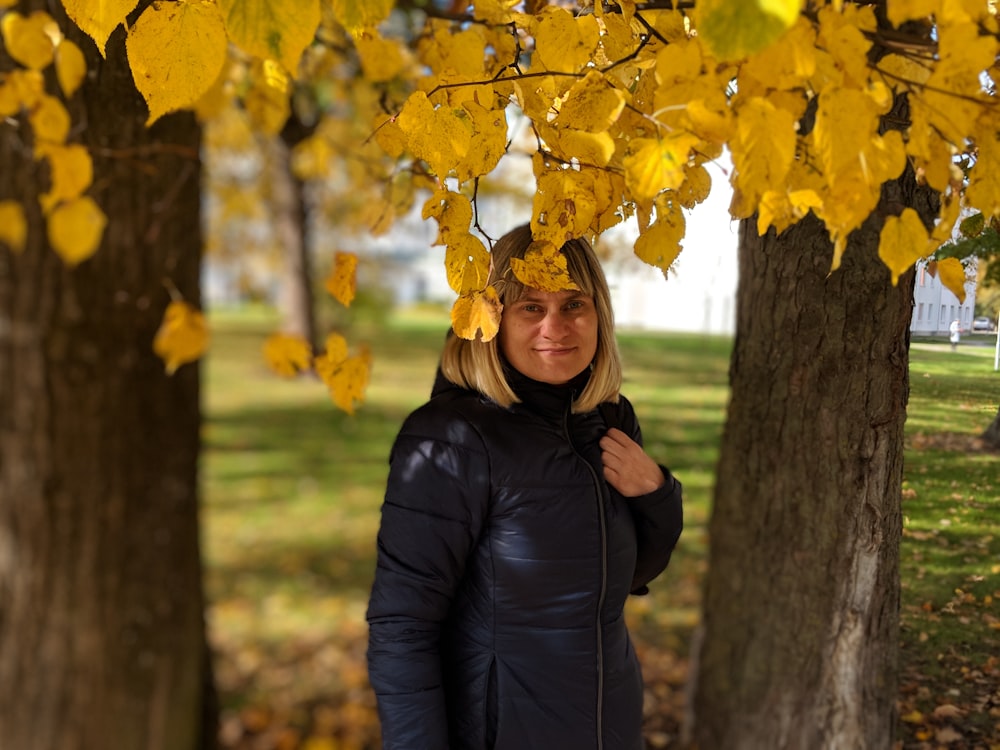 woman under yellow tree