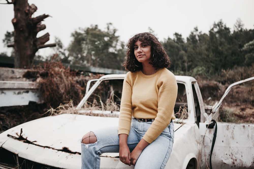 woman sitting on white vehicle