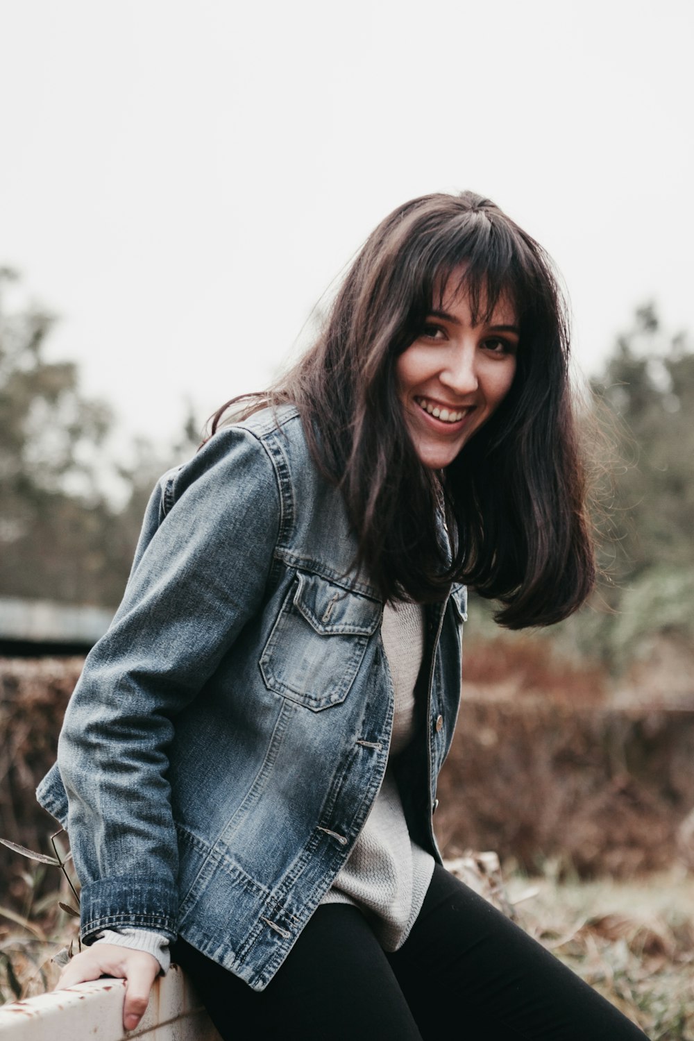 smiling woman wearing blue chambray jacket