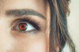 Warm-toned photo of a person gently focusing their eye for the iris scan.