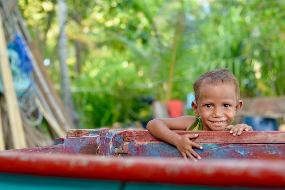 smiling boy near the wood