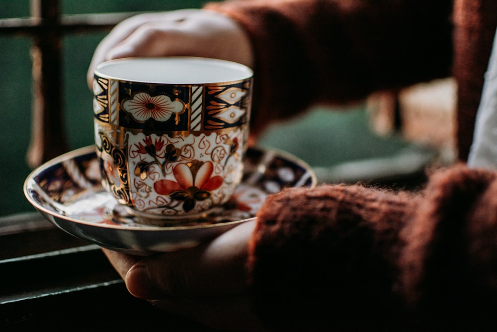 white and black ceramic teacup