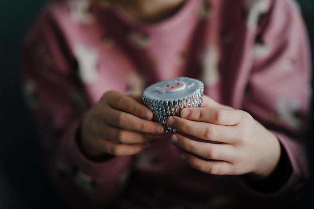 person holding cupcake