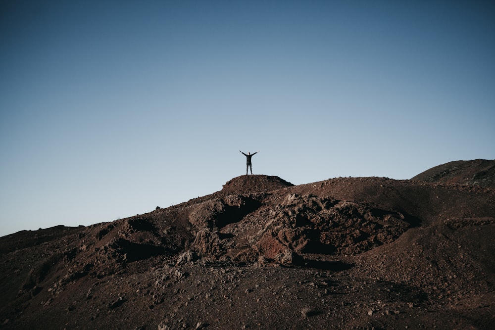 person standing on top of hill