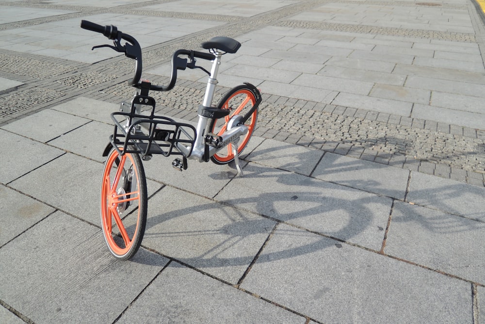 grey and orange folding bike on grey tile