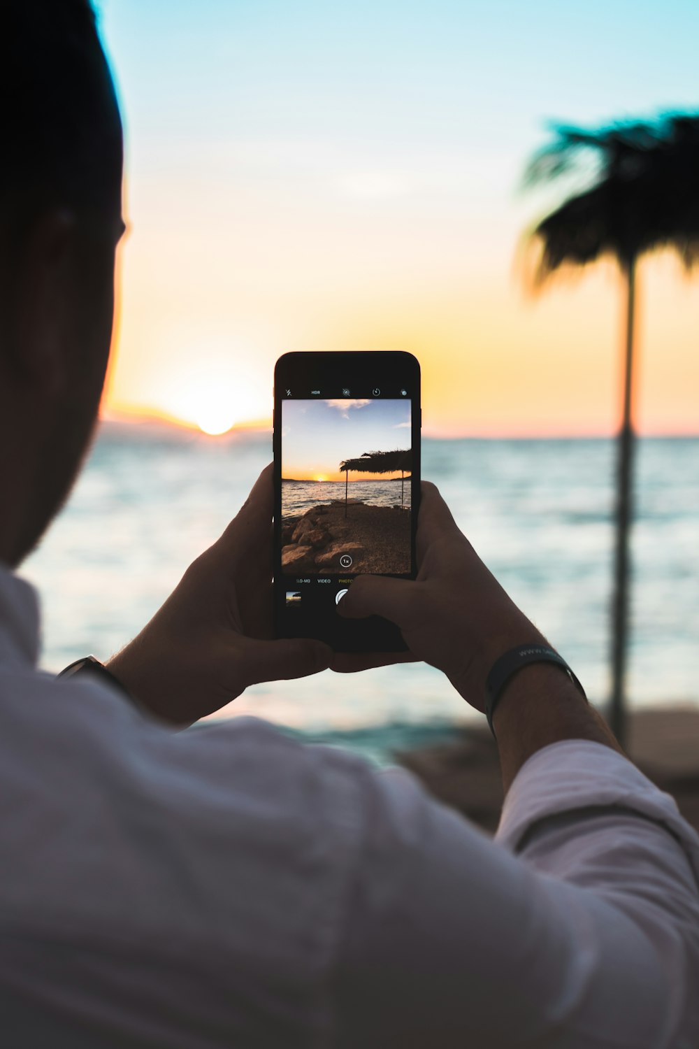 person taking photo of beach