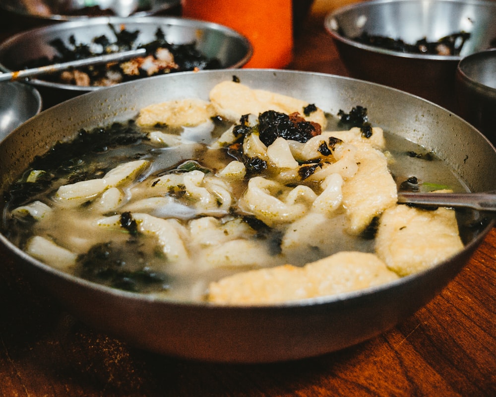 noodle soup on round stainless steel bowl