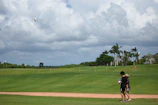 Happy kids outdoors flying small drones under the watchful eye of their instructor.