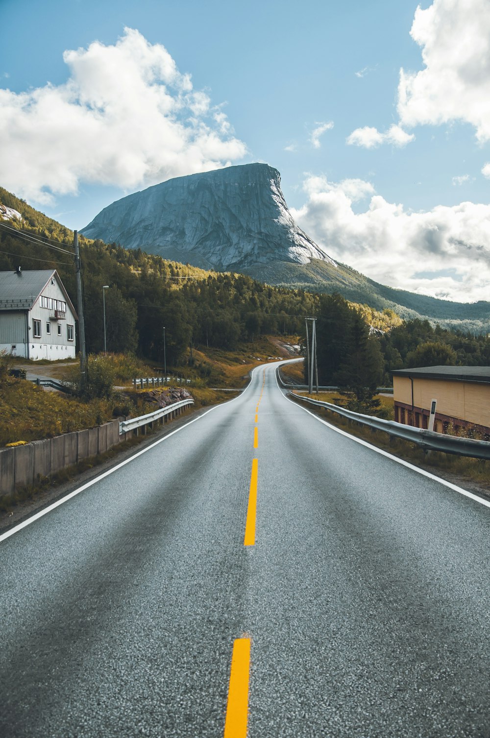 black asphalt road under clear blue sky