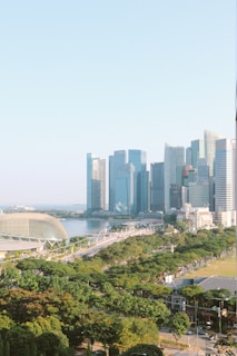 A vibrant city skyline showcasing modern architecture and greenery.