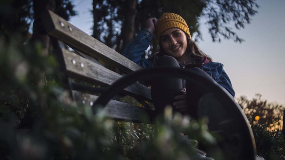 woman in blue denim jacket and brown knit cap