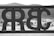 An artistic gate with mirrored lettering appears against a backdrop of mountains and desert landscape. The image is in black and white, with the gate's metalwork prominently featured in the foreground while the natural scenery fades into the background.