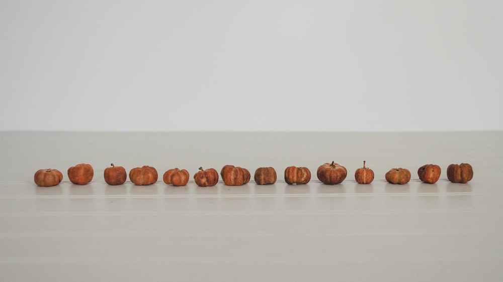 brown pumpkin lot on white surface