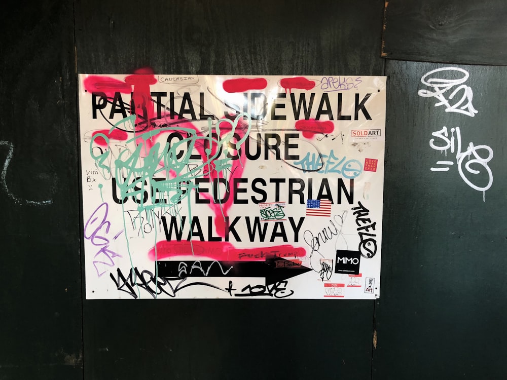 white and multicolored graffiti signage