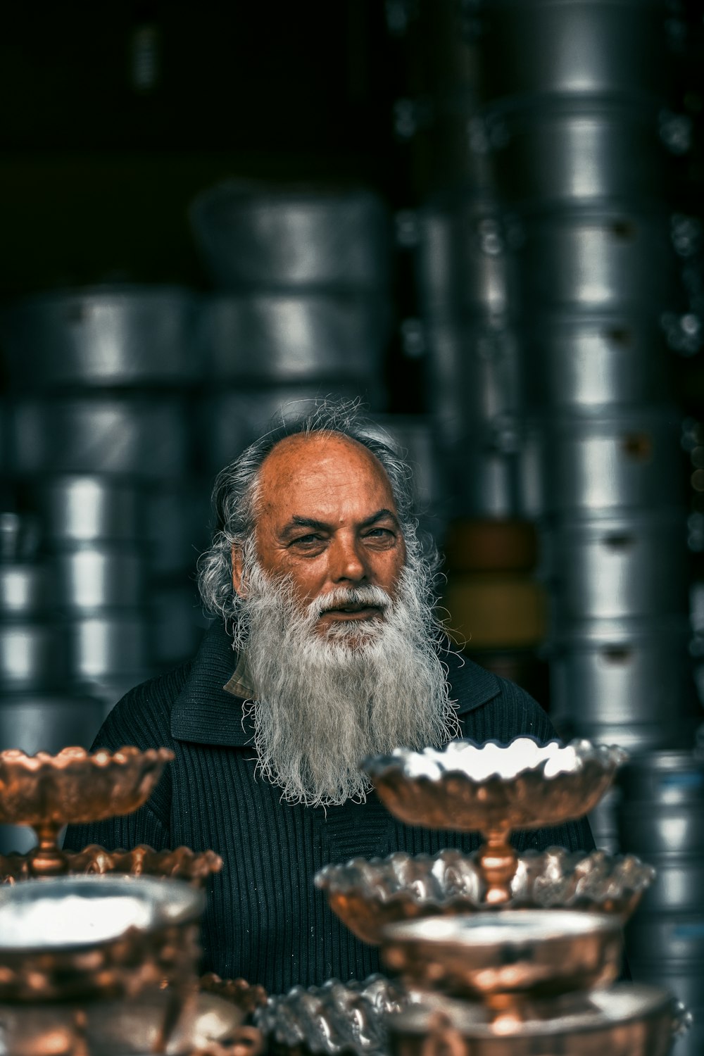 man beside gray stainless steel cooking pots and racks