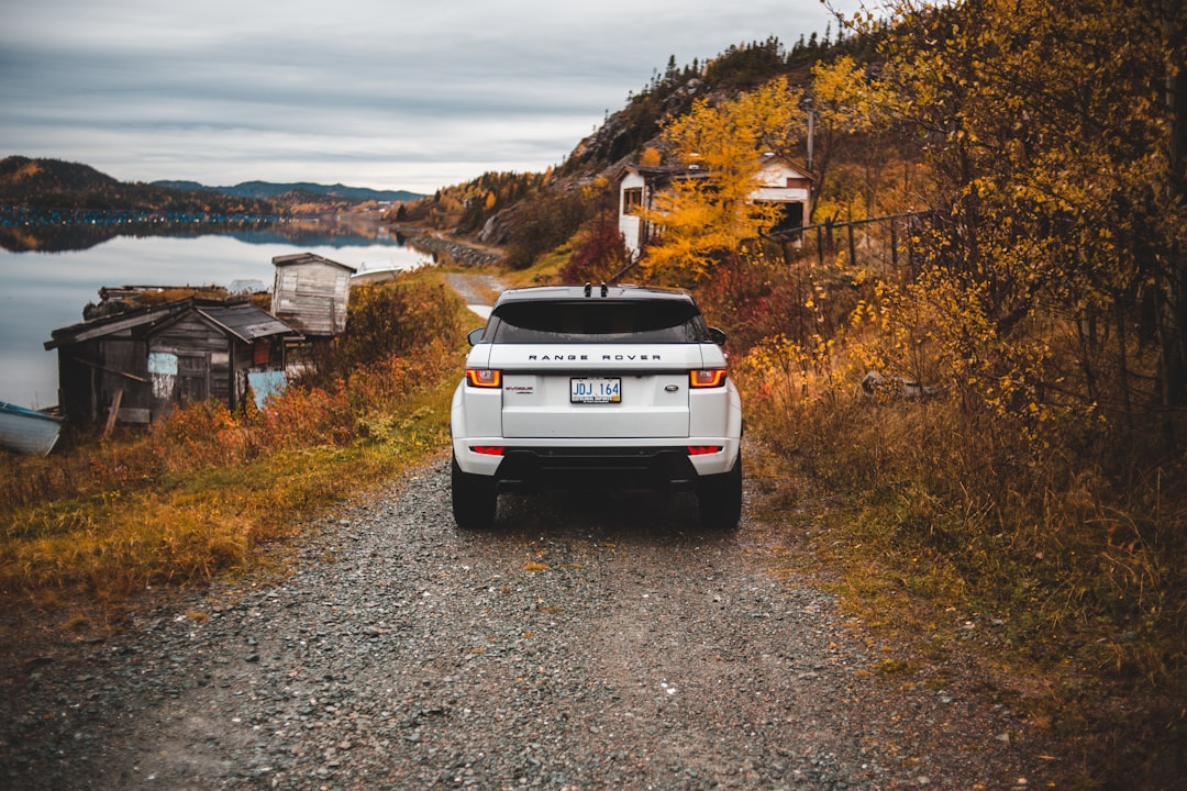 white vehicle on dirt road