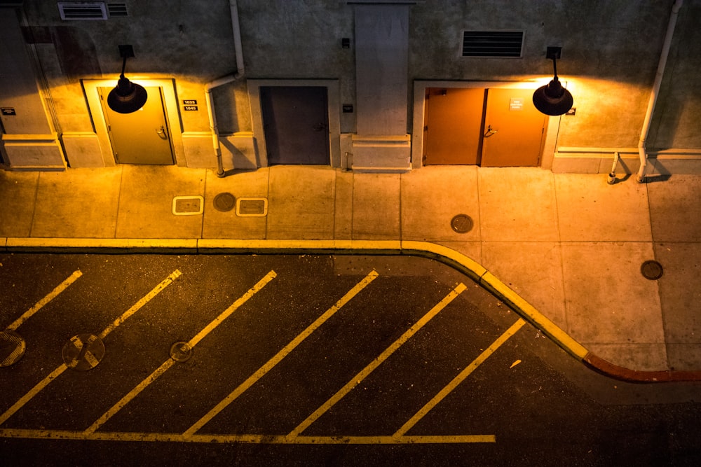 two round turned on street sidewalk lamps