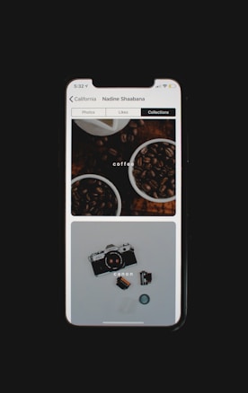 A smartphone screen displays an Instagram-like app interface showing a collection of images. The top image features two cups filled with coffee beans, while the lower image depicts a vintage Canon camera with a roll of film and lens cap beside it.