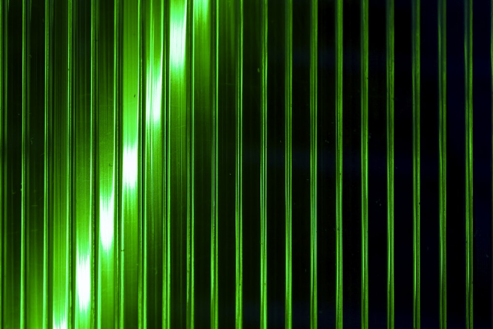 a green and black background with vertical lines