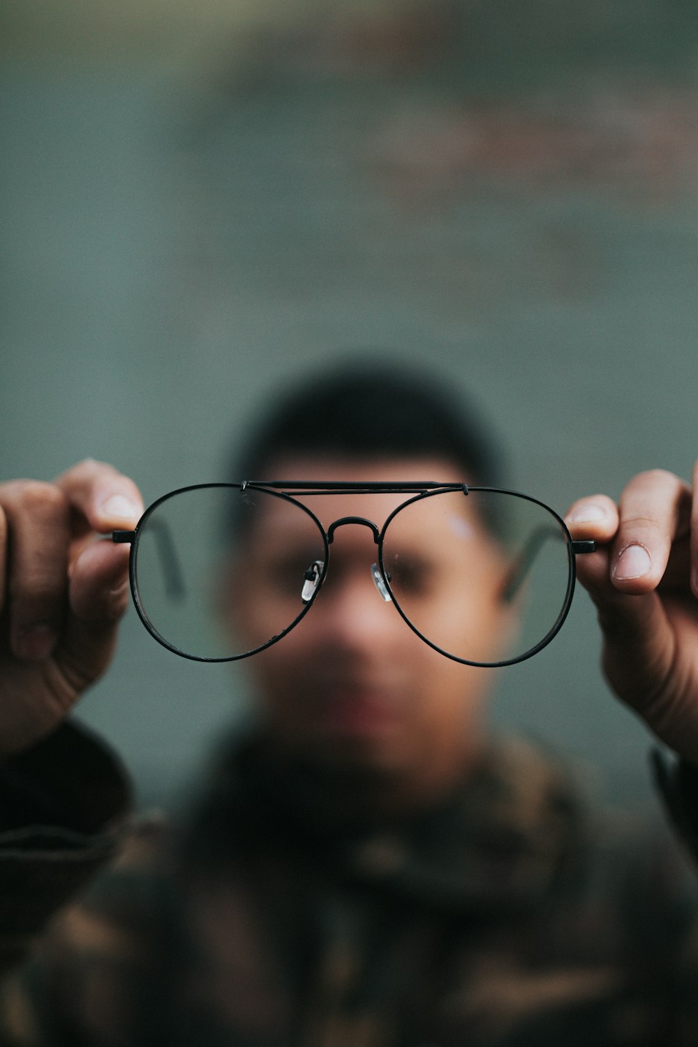 man holding eyeglasses