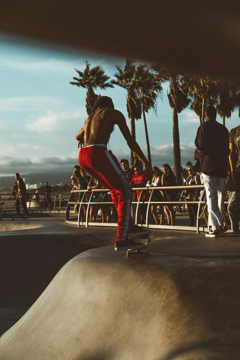 man skateboarding surrounded people at daytime