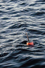 orange fixture floating on body of water during daytime