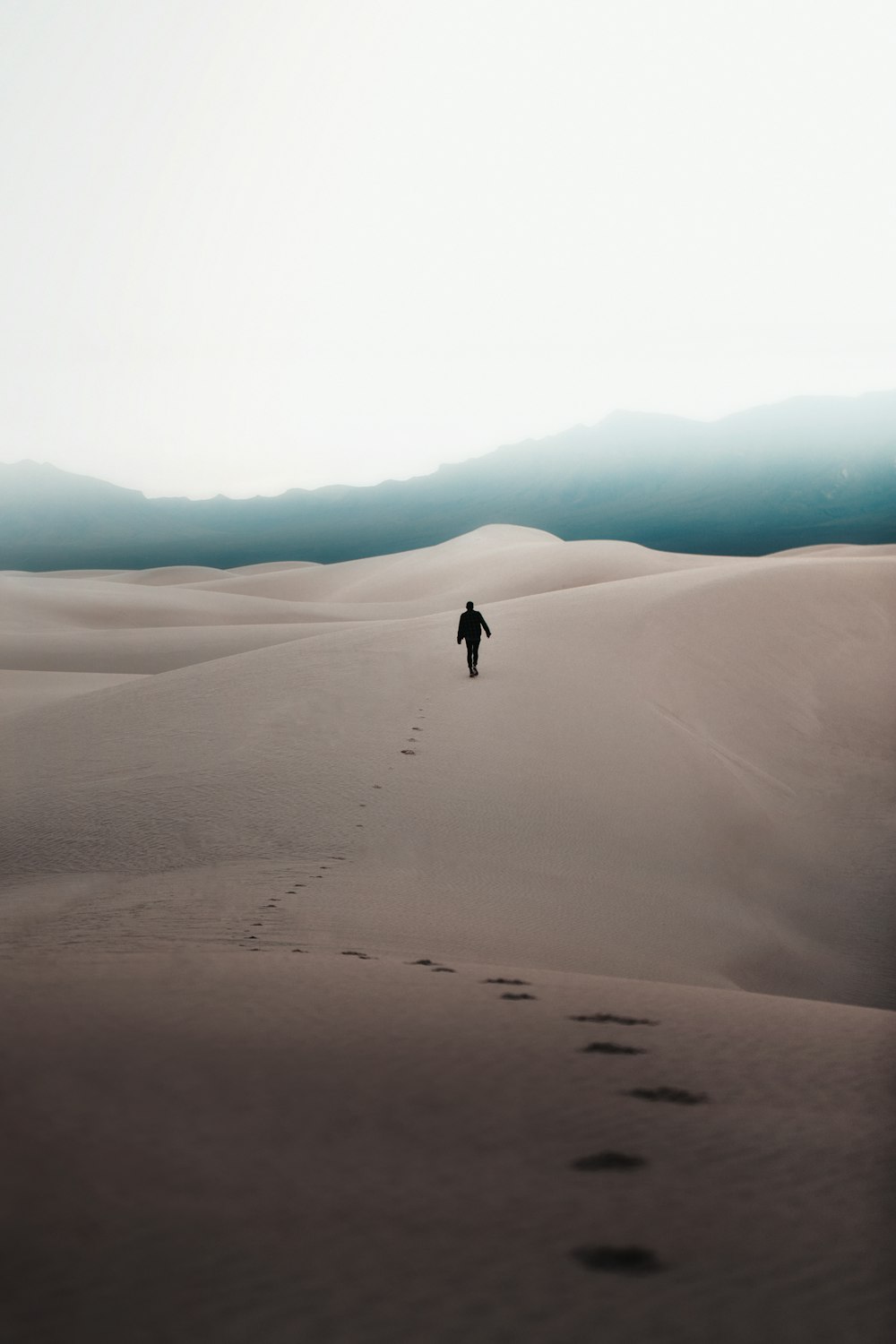 man walking through the desert