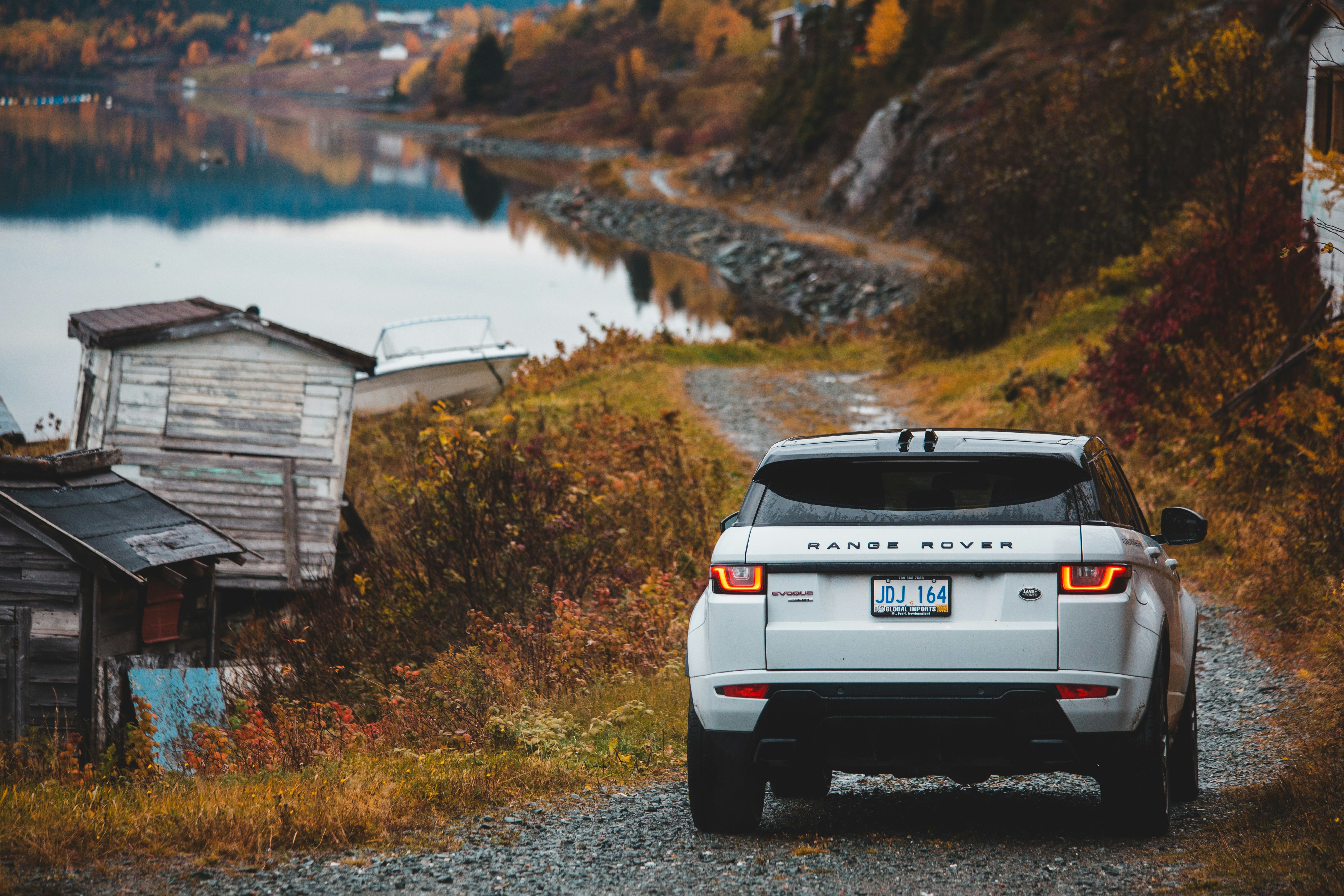 white Land Rover Range Rover car passing on road