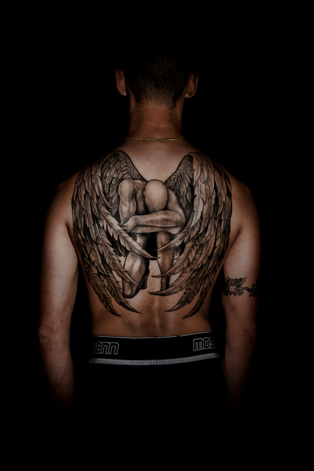 person with kneeling angel back tattoo photo – Free Tattoo Image on Unsplash