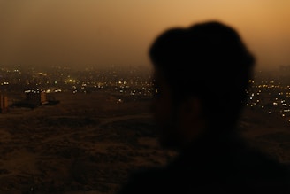 Nighttime shot of São Paulo cityscape with a detective silhouette in the foreground.