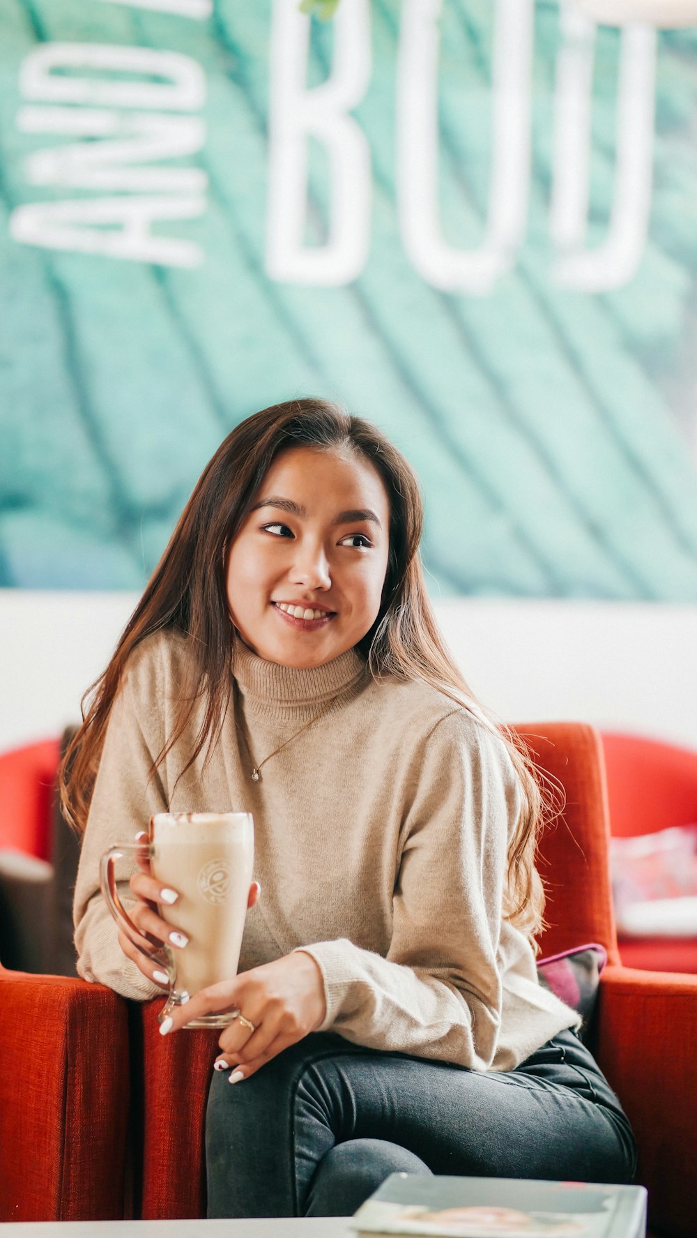 woman sitting on red chair