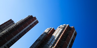 Modern residential buildings with a clear blue sky background.