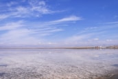 A panoramic view of the Uyuni salt flats with mining equipment in the foreground.
