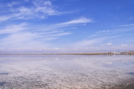 A panoramic view of the Uyuni salt flats with mining equipment in the foreground.