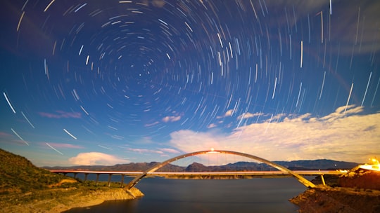 time-lapse photography of bridge across the terrain in Theodore Roosevelt Dam United States