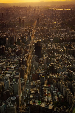 A sweeping drone shot of a bustling downtown Arkansas business district in golden hour light.