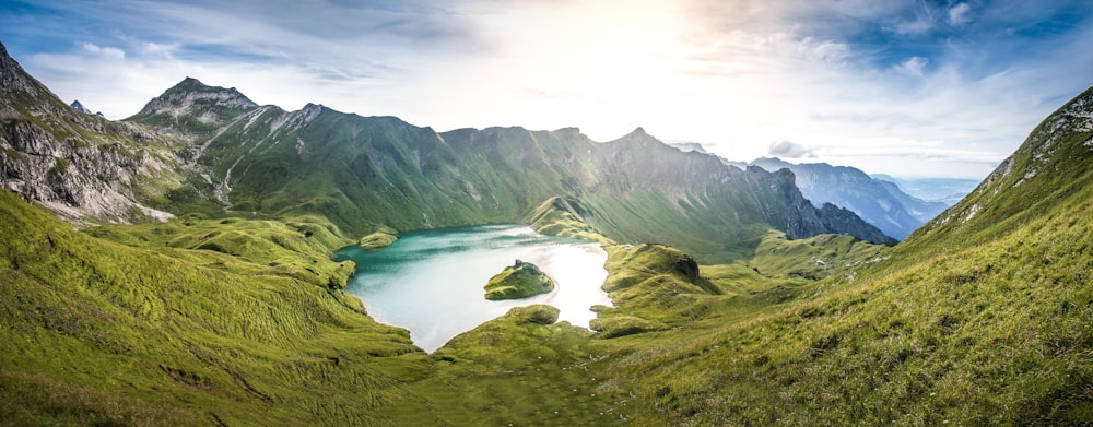 green mountains near lake