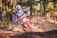 A happy rider on a motocross bike in a lush forest trail near San José del Guaviare.