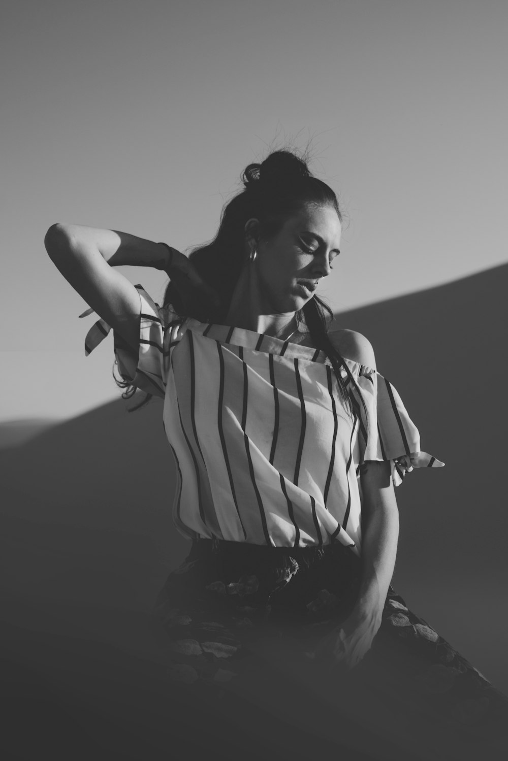 greyscale photo of woman wearing off-shoulder shirt